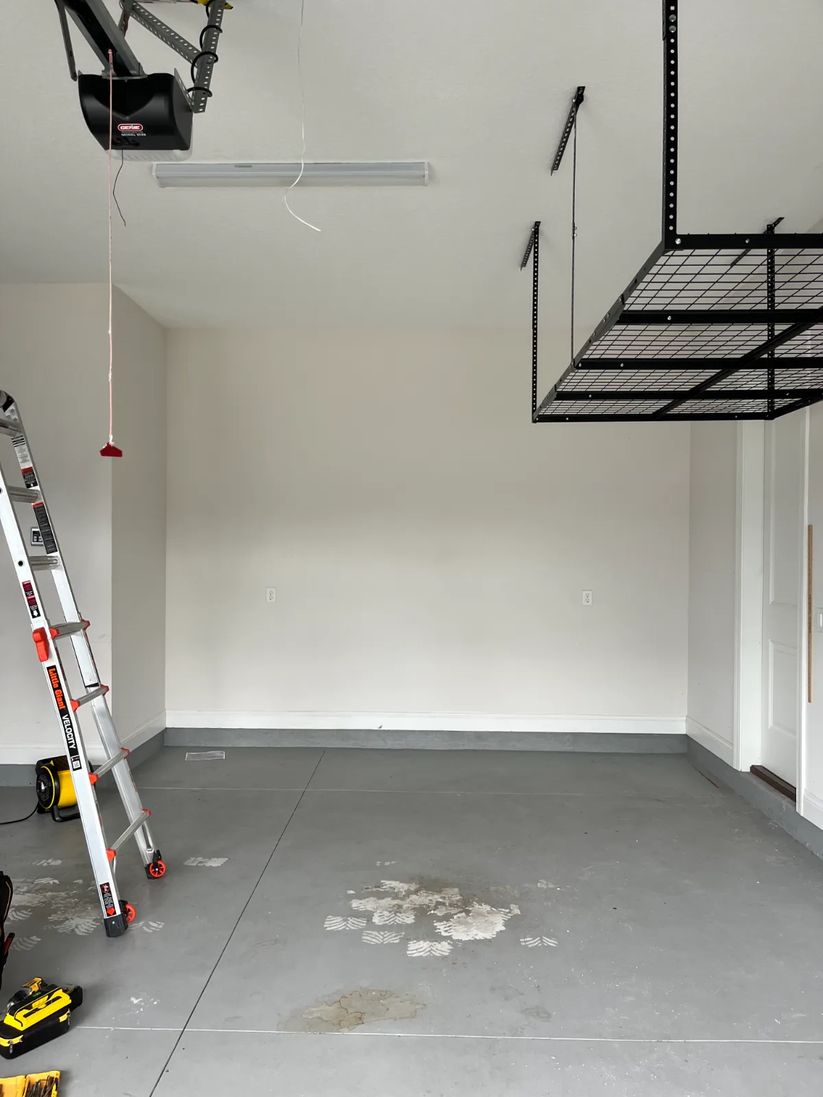 Garage wall before custom wooden shelving installation in Mandarin, FL